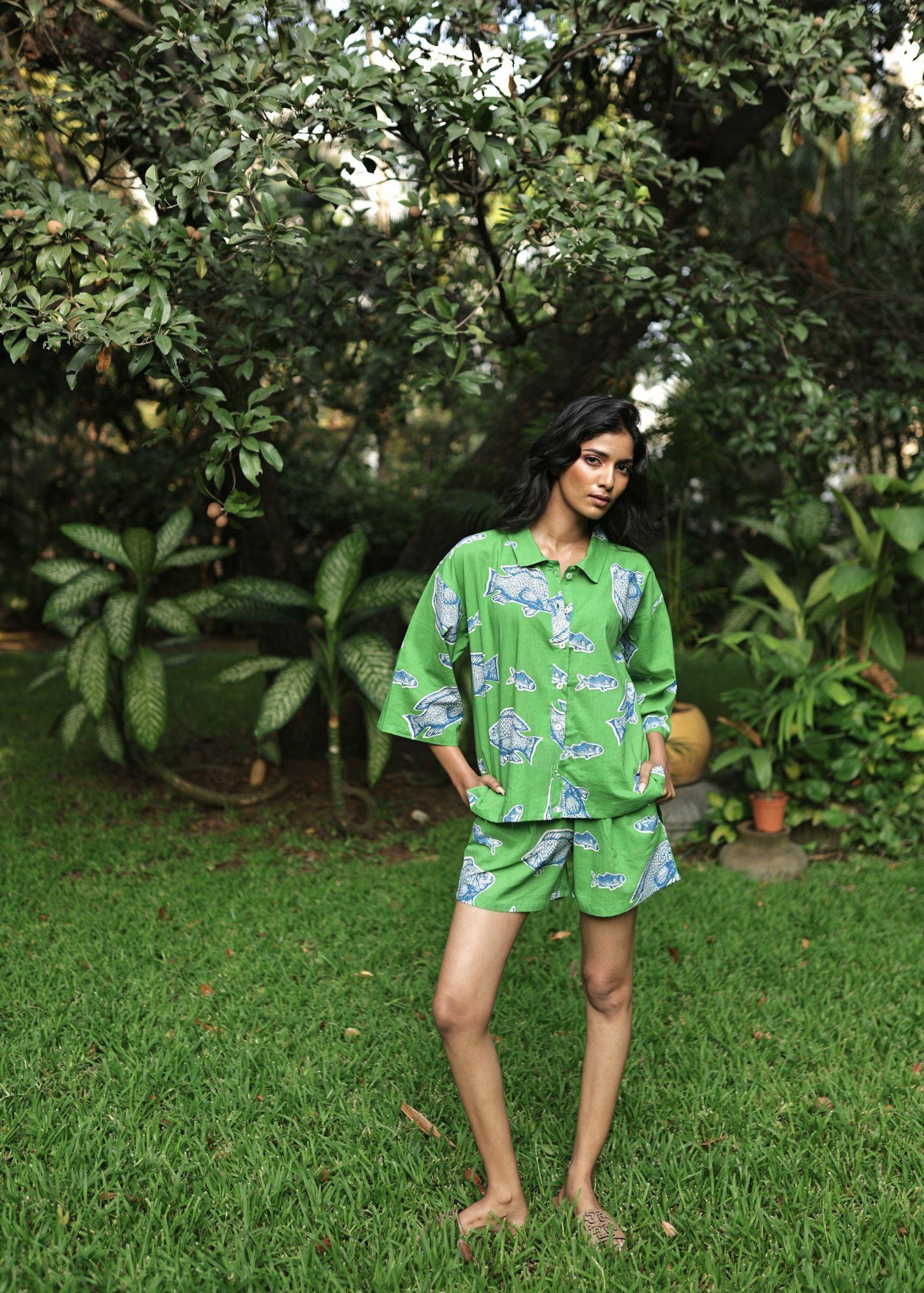 Woman wearing Azurina Green Fish Two Fish print cotton shorts set, luxury resortwear