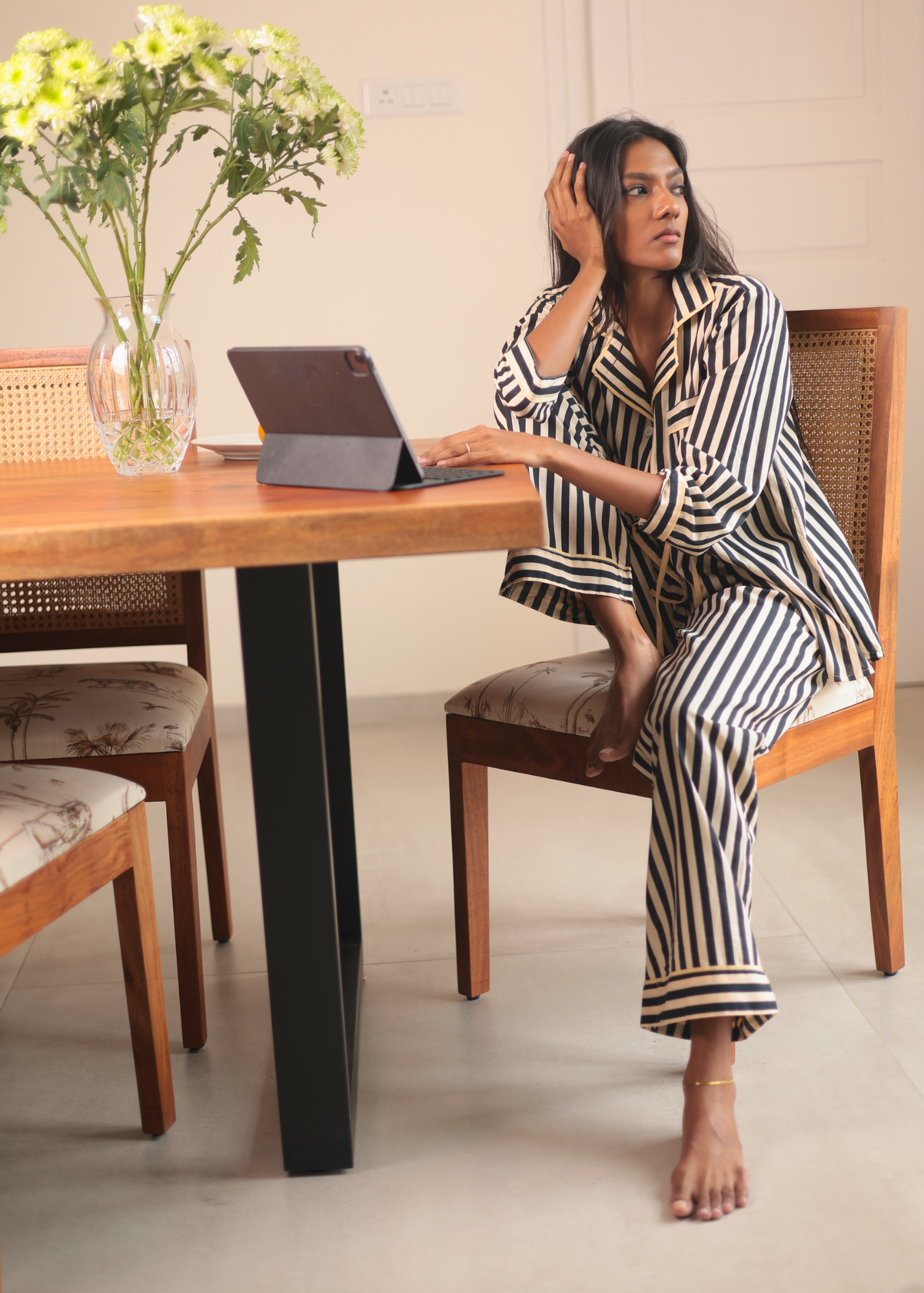 Woman wearing Black Satori print button-down pajama set with beige piping, premium cotton sleepwear